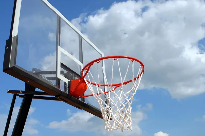 A basketball hoop against the sky.