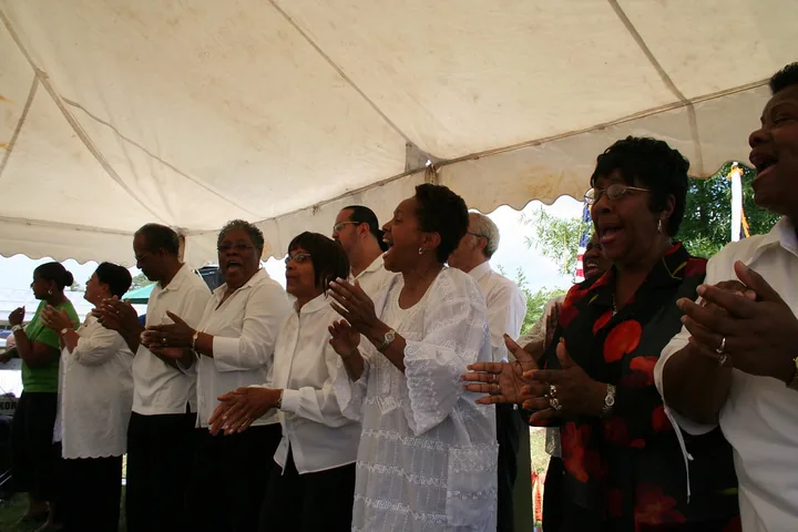A congregation clapping in worship.